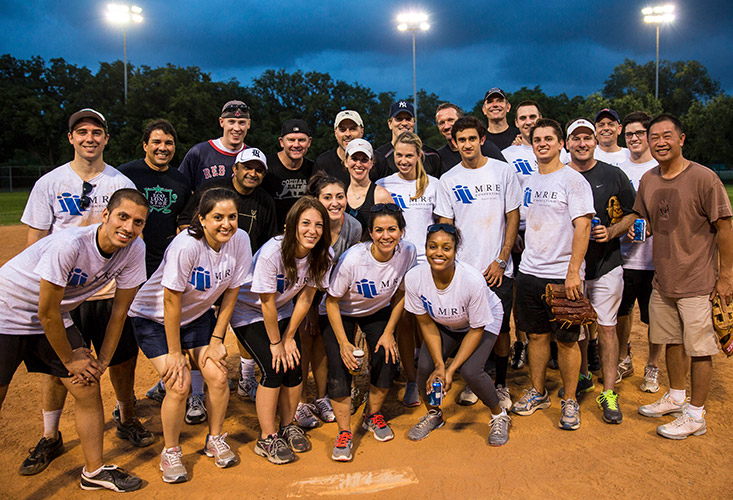 MRE employees posing at a softball game